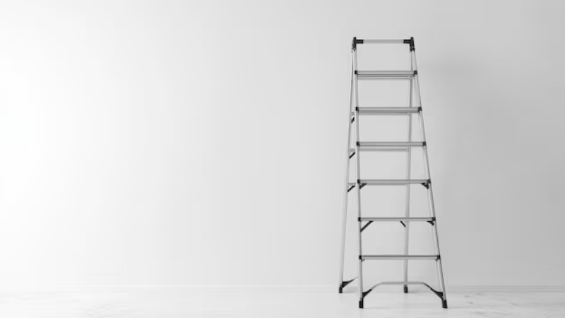 Stainless Steel step ladder standing against a white wall in a minimalistic room